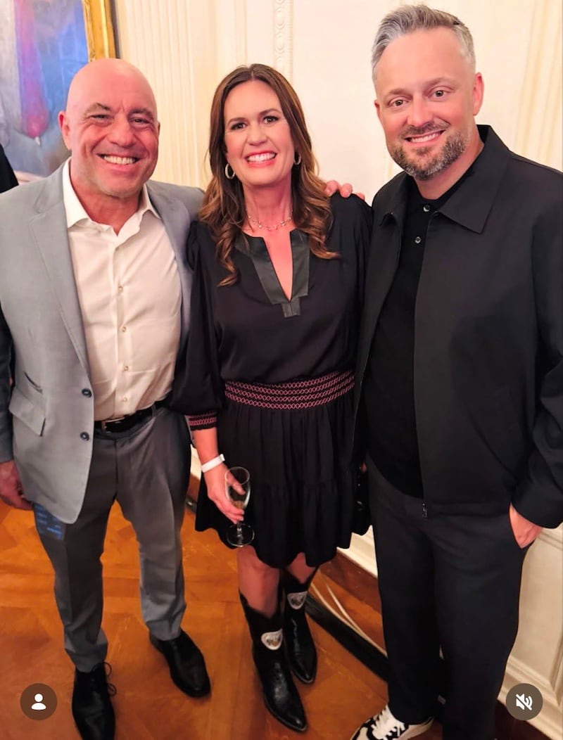 Nate Bargatze poses with Joe Rogan and Sarah Huckabee Sanders.