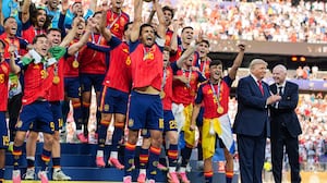 EAST RUTHERFORD, NEW JERSEY - JULY 19: US President Donald Trump and FIFA President Gianni Infantino stand on stage as Rodri #9 of Spain raises the FIFA World Cup Winner’s Trophy with his teammates after they defeated Argentina in the FIFA World Cup 2026 Final at New York New Jersey Stadium on July 19, 2026 in East Rutherford, New Jersey. Spain defeated reigning World Cup champions Argentina, who were led by Lionel Messi, with the lone goal coming from Ferran Torres #7 in the 106th minute of extra time. (Photo by Andrew Harnik/Getty Images)