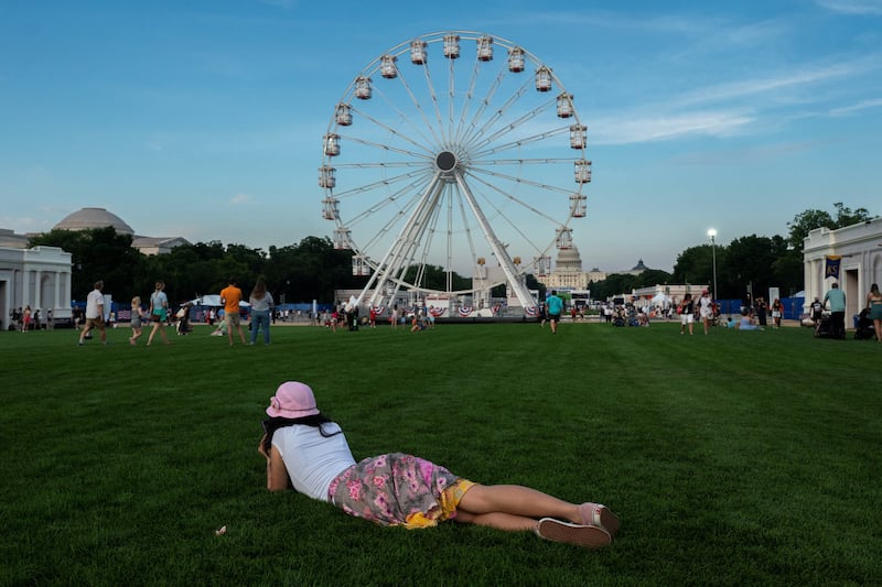 A visitor rests during the Great American State Fair on the National Mall in Washington, D.C., U.S., June 25, 2026.