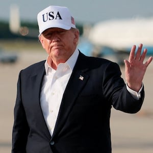 U.S. President Donald Trump waves after disembarking Air Force One following his trip to China at Joint Base Andrews, Maryland, U.S., May 15, 2026.