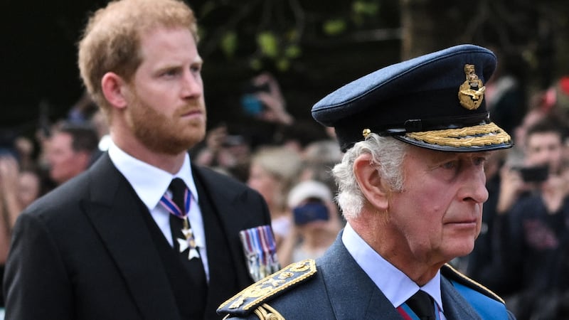King Charles III and Prince Harry walk behind the coffin of Queen Elizabeth II during a procession from Buckingham Palace to the Palace of Westminster in London on September 14, 2022.