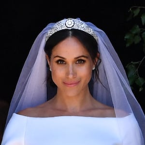 Prince Harry and Meghan Markle walk down the west steps of St. George's Chapel at Windsor Castle on May 19, 2018. Waight designed Markle's sweeping, boatneck Givenchy bridal gown.