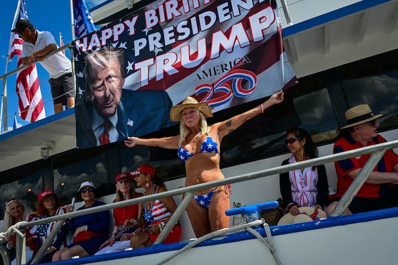 Supporters of U.S. President Donald Trump hold flags before setting off in a boat parade marking his birthday, on Flag Day, in West Palm Beach, Florida, U.S., June 14, 2026.