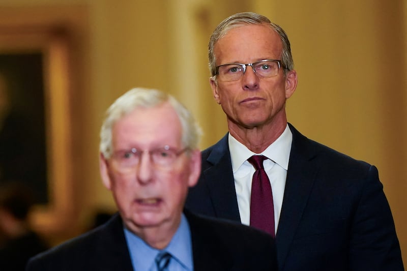 U.S. Senator John Thune (R-SD) is seen as Minority Leader Mitch McConnell (R-KY) speaks during a press conference following the Senate Republicans weekly policy lunch at the U.S. Capitol in Washington, U.S., November 19, 2024.