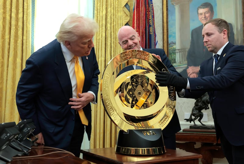 WASHINGTON, DC - MARCH 07: U.S. President Donald Trump and President of Fédération Internationale de Football Association (FIFA) Gianni Infantino unveil the 2025 Club World Cup trophy in the Oval Office at the White House on March 07, 2025 in Washington, DC. President Trump signed an executive order establishing a White House Task Force for the 2026 World Cup.  (Photo by Anna Moneymaker/Getty Images)