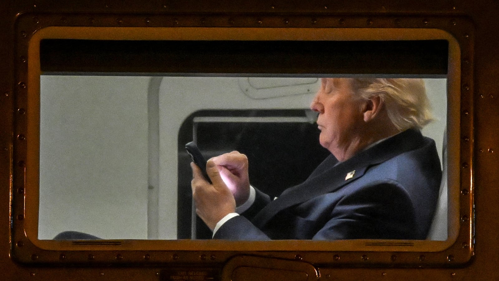 US President Donald Trump uses a cellphone