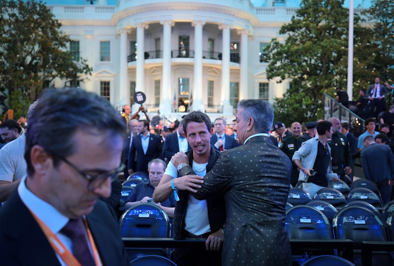 WASHINGTON, DC - JUNE 14: American comedian Tony Hinchcliffe (center) attends UFC Freedom 250 on the South Lawn of the White House on June 14, 2026 in Washington, DC. President Trump is hosting a series of Ultimate Fighting Championship matches on his 80th birthday, which the White House is calling "a once-in-a-generation celebration of the American fighting spirit.” (Photo by Chip Somodevilla/Getty Images)
