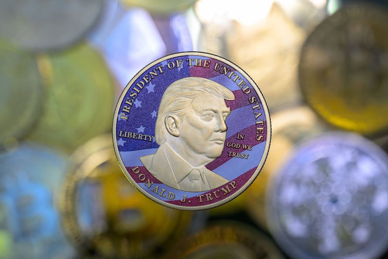 This photo illustration shows a representation of cryptocracy coins with the $Trump meme coin (collection coin) in Brussels, Belgium, on March 3, 2025.