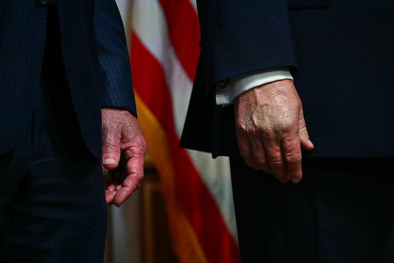The hands of US Secretary of Health and Human Services Robert F. Kennedy Jr. (L) and US President Donald Trump are seen at a healthcare affordability event in the South Court Auditorium of The White House in Washington, DC, on May 18, 2026.