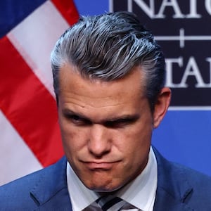 U.S. Defense Secretary Pete Hegseth looks on as U.S. President Donald Trump speaks to the media at the end of his participation in the NATO leaders summit in Ankara, Turkey, July 8, 2026. REUTERS/Yves Herman
