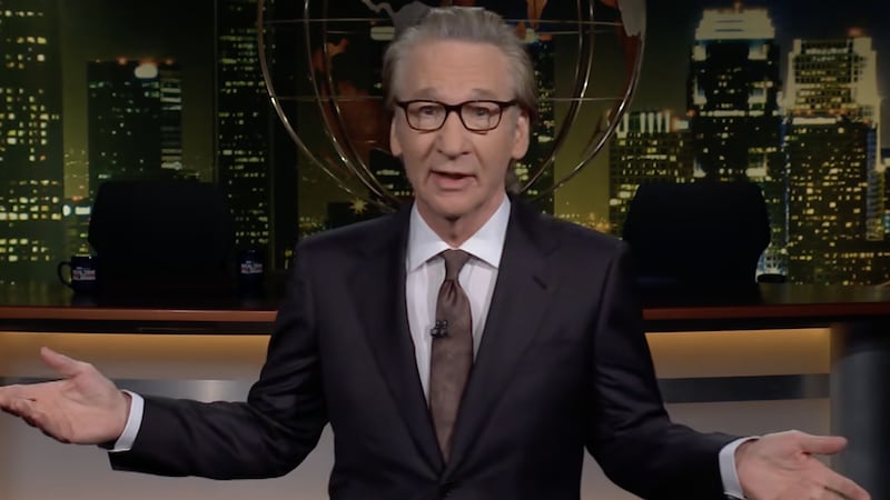 Bill Maher stands on the set of his eponymous late-night show during the monologue segment.