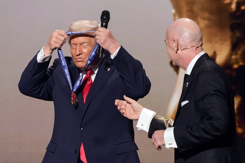 U.S. President Donald Trump wears a medal as he is awarded the FIFA Peace Prize at the Kennedy Center in Washington, D.C., U.S., December 5, 2025.