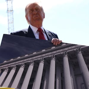 U..S. President Donald Trump shows an image of the concept at the site of ongoing construction of the planned White House ballroom in Washington, D.C., U.S., May 19, 2026. REUTERS/Kevin Lamarque