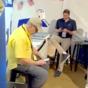 Two men sat down on their phones.