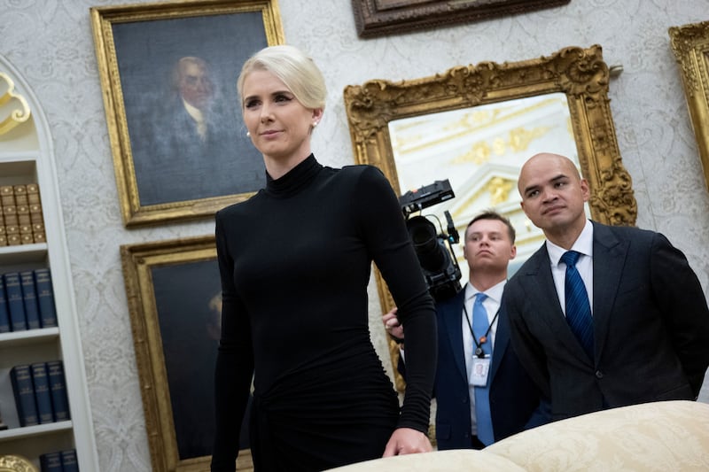 Executive Assistant to the President Natalie Harp, 34,  stands in the Oval Office on March 31.