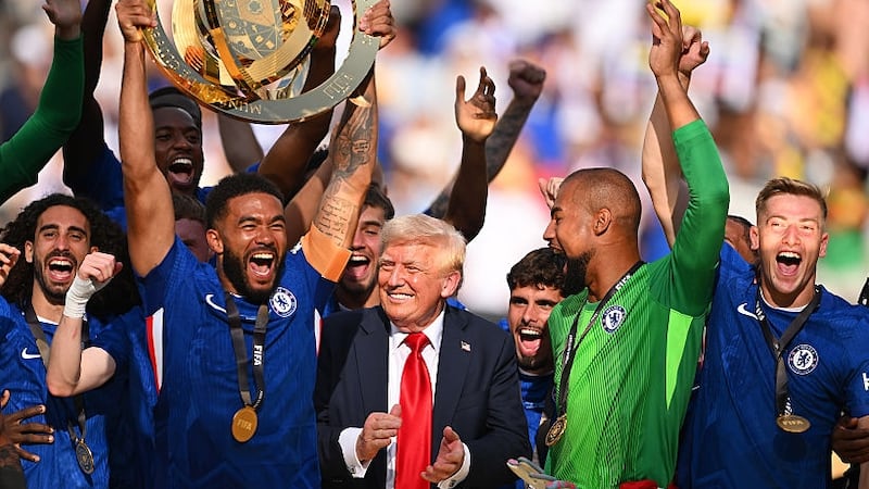 Reece James #24 of Chelsea FC lifts the FIFA Club World Cup trophy after their team's victory as U.S. President Donald Trump reacts following  the FIFA Club World Cup 2025 Final match between Chelsea FC and Paris Saint-Germain at MetLife Stadium on July 13, 2025 in East Rutherford, New Jersey.
