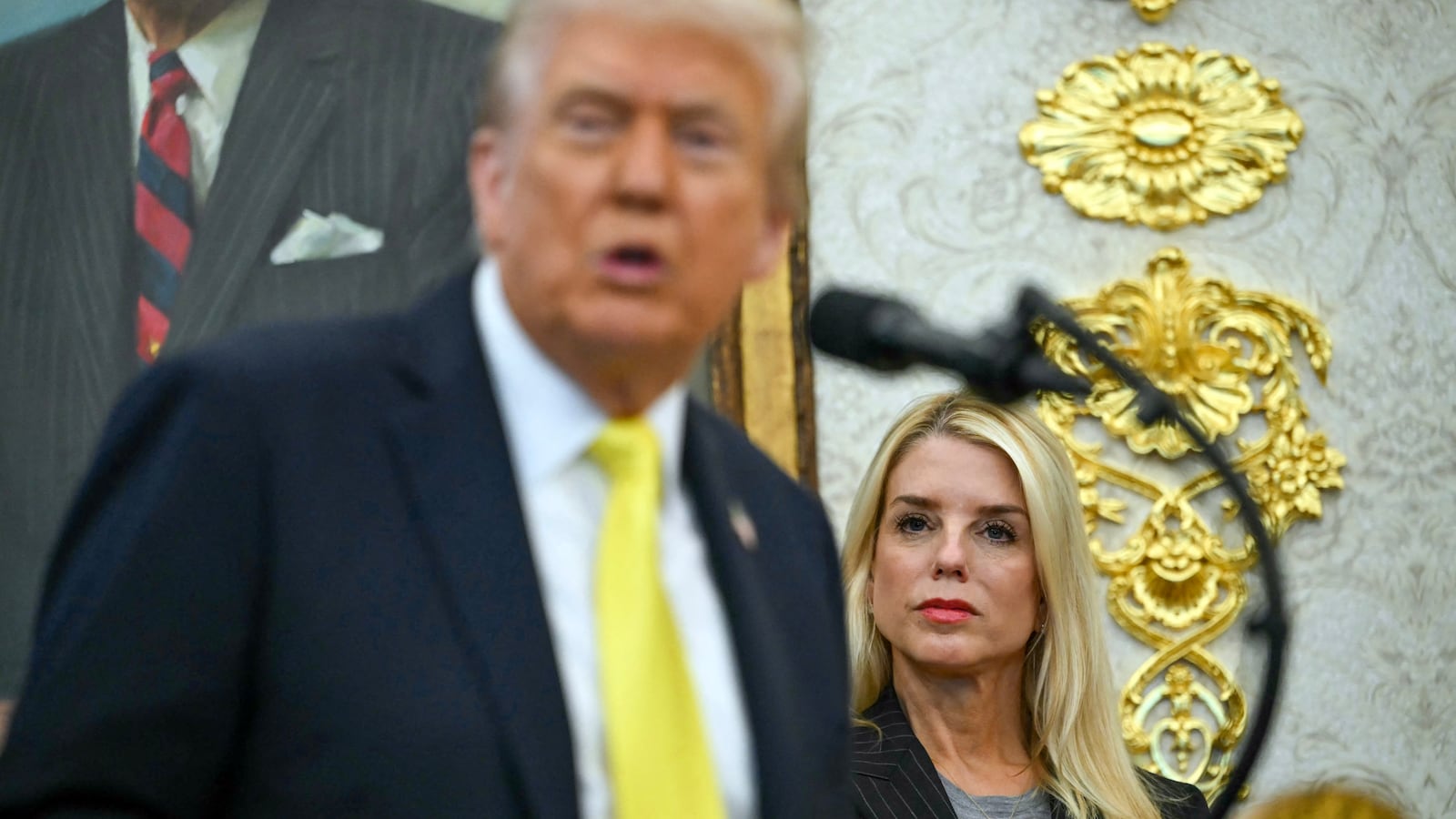 US Attorney General Pam Bondi listens as President Donald Trump speaks during a news conference in the Oval Office of the White House in Washington, DC, on October 15, 2025. (Photo by ANDREW CABALLERO-REYNOLDS / AFP) (Photo by ANDREW CABALLERO-REYNOLDS/AFP via Getty Images)