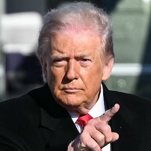 US President Donald Trump gestures as he walks to board Air Force One at Joint Base Andrews, Maryland on January 13, 2026.