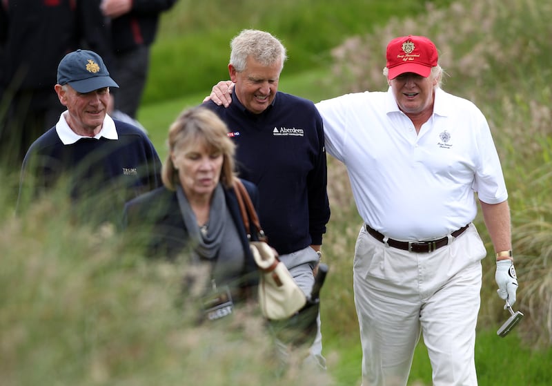 Donald Trump and Colin Montgomerie share a joke after the opening of The Trump International Golf Links Course on July 10, 2012 in Balmedie, Scotland.