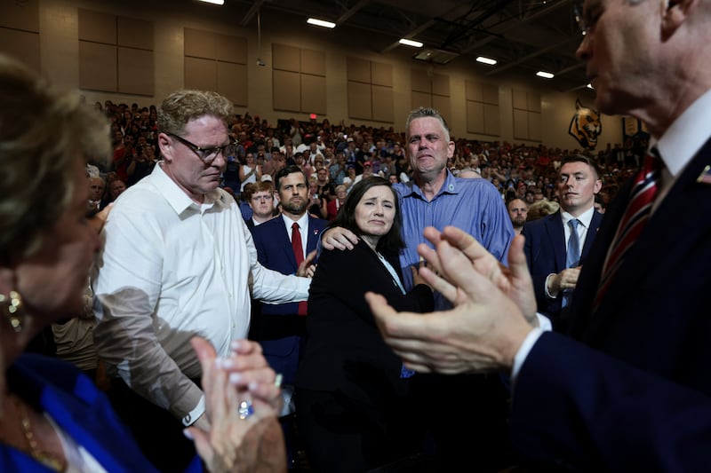 Family members of U.S. Army 1st Lt. Tyler James Feehan of the 2nd Battalion, 55th Air Defense Artillery Regiment, 32nd Army Air and Missile Defense Command, who was killed in an attack at Muwaffaq Salti Air Base in Jordan, are applauded as U.S. President Donald Trump delivers remarks on the "Trump Accounts" tax-advantaged investment program at Wheeler High School in Marietta, Georgia, U.S., July 22, 2026. REUTERS/Evelyn Hockstein