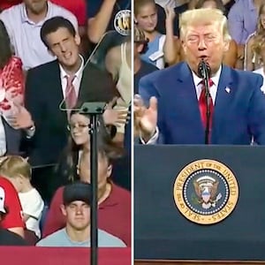 A man in the crowd gestures while President Trump speaks during a visit to Marietta, Georgia.