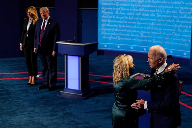 First lady Melania Trump stands with President Donald Trump as he looks at Democratic presidential candidate former Vice President Joe Biden as he is hugged by his wife Jill Biden during the first presidential debate at the Health Education Campus of Case Western Reserve University on September 29, 2020 in Cleveland, Ohio. This is the first of three planned debates between the two candidates in the lead up to the election on November 3.  (Photo by Morry Gash-Pool/Getty Images)
