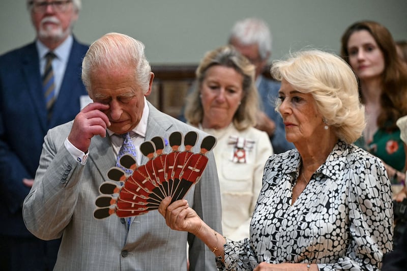 Britain's Queen Camilla fans Britain's King Charles III as they listen to a performance of Dorset Opera, during a visit to the Main Hall at the Blandford Forum Town Hall and Corn Exchange in Blandford Forum, Dorset, south-west England on July 16, 2026.     JUSTIN TALLIS/Pool via REUTERS     TPX IMAGES OF THE DAY
