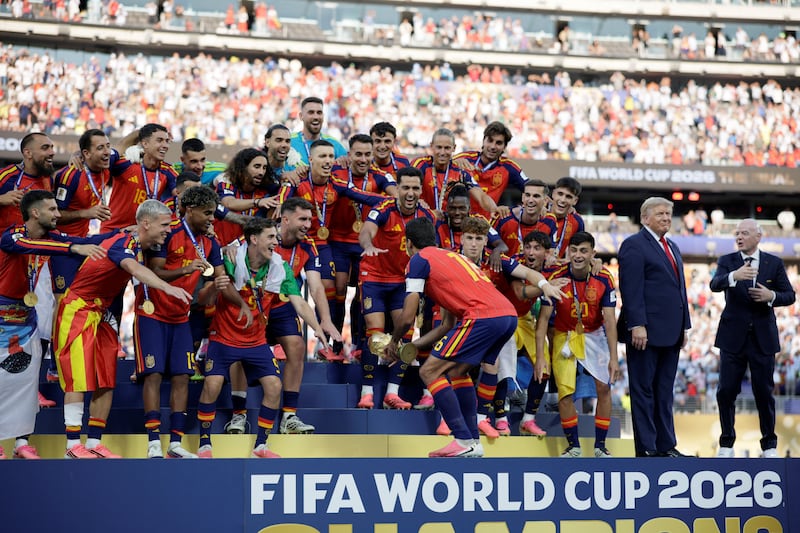 U.S. President Donald Trump presents the FIFA World Cup trophy to Spain after its victory in the 2026 World Cup final at New York New Jersey Stadium in East Rutherford, New Jersey, U.S., July 19, 2026.