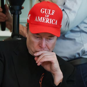 Elon Musk wears a red cap with the words "Gulf of America" as he attends a cabinet meeting at the White House.