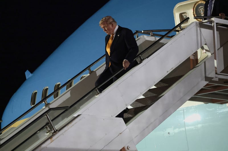 U.S. President Donald Trump walks down the stairs during a stop to switch to the Qatari-gifted Air Force One after arriving on one of the older planes operating as Air Force One, to return to Washington after his participation in a NATO leaders summit in Turkey, at RAF Mildenhall, in Suffolk, Britain, July 8, 2026.